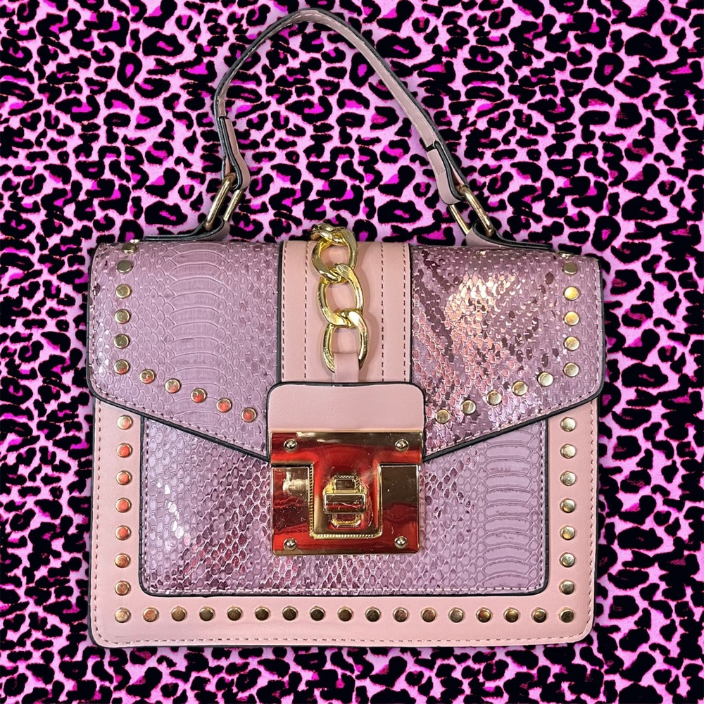 Pink snakeskin print medium sized rectangular shaped purse with detachable strap